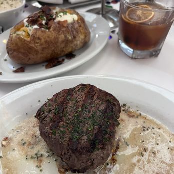 Ruth's Chris Steak House - Center cut filet 11oz with loaded baked potato and brown butter old fashioned served smoked. - Steakhouses Near Me - Anaheim, California Ruth's Chris Steak House - Center cut filet 11oz with loaded baked potato and brown butter old fashioned served smoked. - Steakhouses Near Me - Anaheim, California