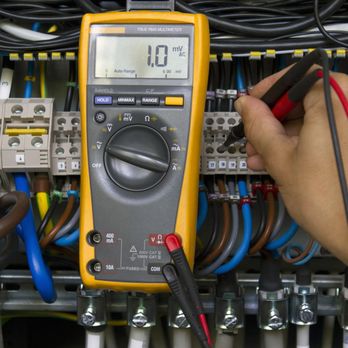 Firefly Electricians - a person using a multimeter - Electricians Near Me - Tulsa, Oklahoma