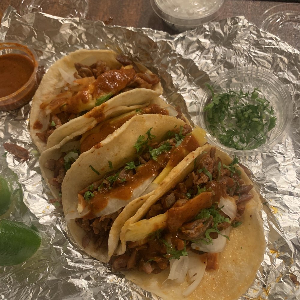 a variety of tacoss on tin foil a variety of tacoss on tin foil