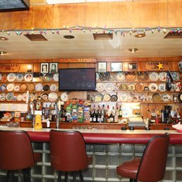 a bar with red chairs