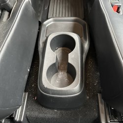 Midway Express Car Wash - Middle console, they did not remove a gum wrapped and it is obvious that it was neither vacuumed or wiped down.