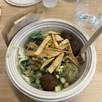 CAVA - Falafels, pita chips, eggplant, supergreen mix, brown rice, and hummus. - Mediterranean Near Me - Boston, Massachusetts