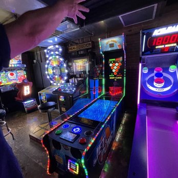 Liquid Lounge - a man playing a game of pinball - Cocktail Bars Near Me - Boise, Idaho Liquid Lounge - a man playing a game of pinball - Cocktail Bars Near Me - Boise, Idaho