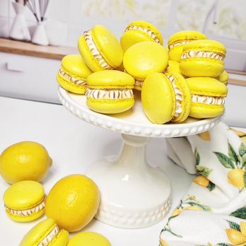 Patty Cake Confections - a plate of yellow macarons - Desserts Near Me Patty Cake Confections - a plate of yellow macarons - Desserts Near Me