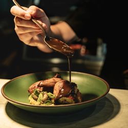 Drizzling sauce on food at Golden Hour