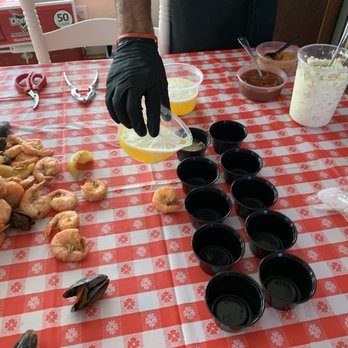 Outer Banks Boil Company - Matt prepping the cups of melted butter - Seafood Near Me - Corolla, North Carolina Outer Banks Boil Company - Matt prepping the cups of melted butter - Seafood Near Me - Corolla, North Carolina