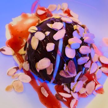 Nova - a dessert with chocolate and almonds on a white plate - Gastropubs Near Me - Dallas, Texas Nova - a dessert with chocolate and almonds on a white plate - Gastropubs Near Me - Dallas, Texas