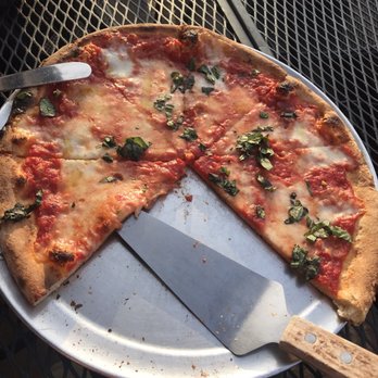 The Brick - a pizza with a slice taken out of it - Pizza Near Me - Bethlehem, Pennsylvania