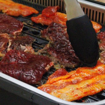 H Mart - Cambridge - a grill with meat being cooked - Grocery Near Me - Cambridge, Massachusetts H Mart - Cambridge - a grill with meat being cooked - Grocery Near Me - Cambridge, Massachusetts