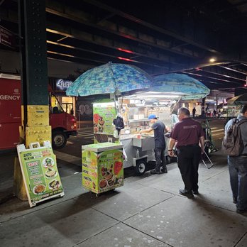 Antojitos Charly - a group of people at a food stand - Food Trucks Near Me - Queens, New York