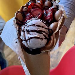 Crispy waffle-like shell, with strawberries, strawberry ice cream, and chocolate syrup