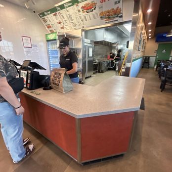 Wingstop - An employee showing an order with a big smile !! I love the employees here. - Chicken Wings Near Me - Moreno Valley, California