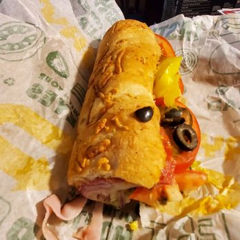 Subway - a sandwich on a wrapper with olives and peppers - Sandwiches Near Me - Soledad, California Subway - a sandwich on a wrapper with olives and peppers - Sandwiches Near Me - Soledad, California