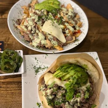 Arepitas - La llanera on the right and on the back is the parrillada with fries - Venezuelan Near Me - Round Rock, Texas Arepitas - La llanera on the right and on the back is the parrillada with fries - Venezuelan Near Me - Round Rock, Texas
