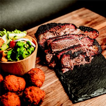 R&R BBQ - a steak and a salad on a cutting board - Barbeque Near Me - Meridian, Idaho R&R BBQ - a steak and a salad on a cutting board - Barbeque Near Me - Meridian, Idaho
