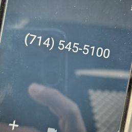 a hand holding a cell phone a hand holding a cell phone