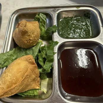 New Kamana Kitchen - Veggie samosa appetizer. Served with mint and tamarind chutneys - Indian Near Me - Honolulu, Hawaii New Kamana Kitchen - Veggie samosa appetizer. Served with mint and tamarind chutneys - Indian Near Me - Honolulu, Hawaii