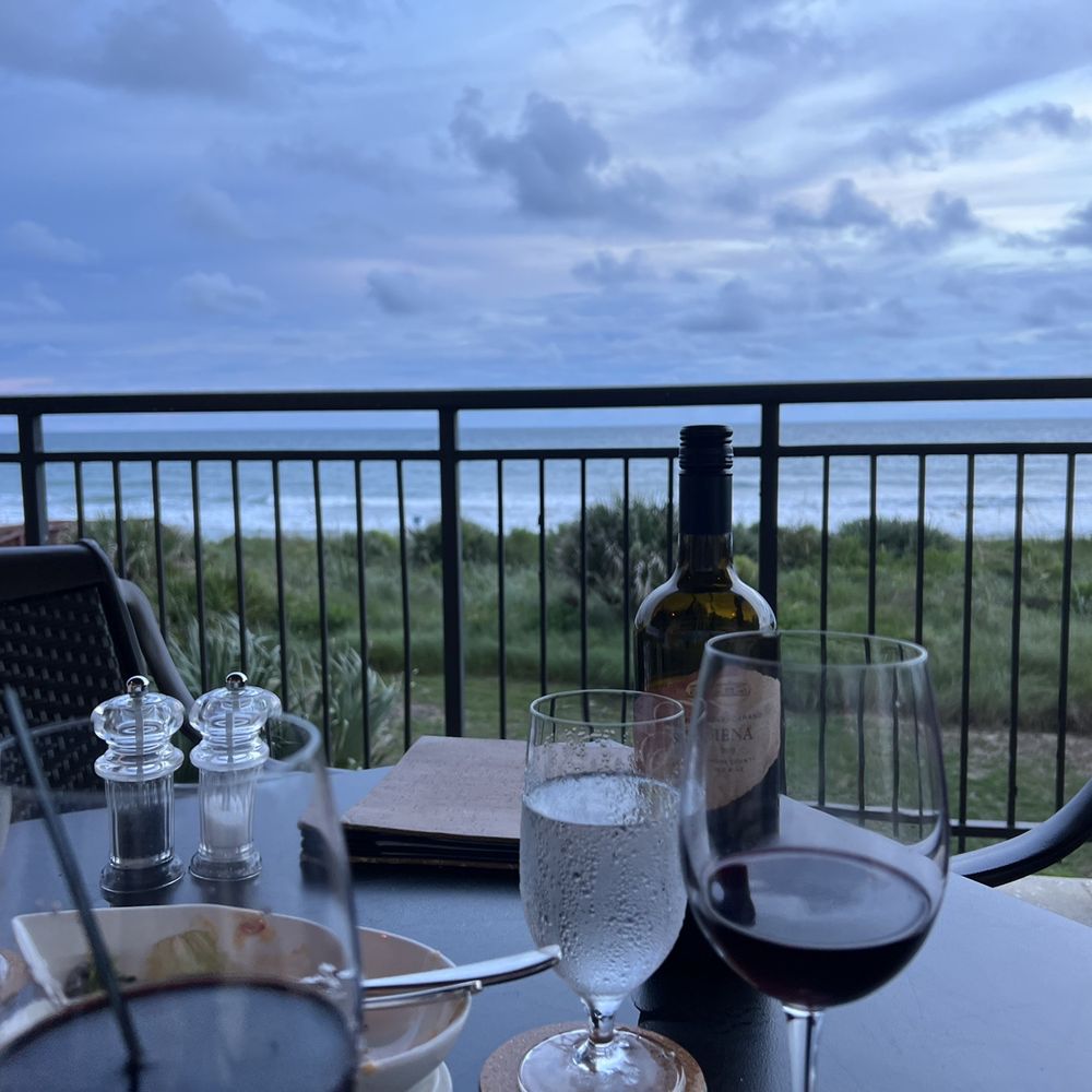 Atlantic Grille - a glass of wine and a bottle of wine on a table - Seafood Near Me - Palm Coast, Florida
