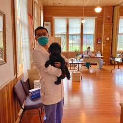 Salem Acupuncture and Traditional Chinese Medicine - Acupuncturist Leo Zhu and clinic dog James. Acupuncturist Benson Huang at the desk.