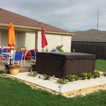 Smith Landscaping - a patio with a hot tub - Landscaping Near Me