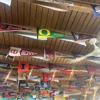 Skinny Legs Bar and Grill - All the college teams pennants in the US line the rafters. - Burgers Near Me - St John, Virgin Islands