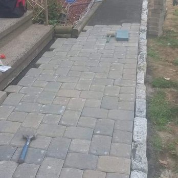 Sergio Landscaping - a paver walkway being laid in front of a house - Tree Services Near Me - New Milford, Connecticut Sergio Landscaping - a paver walkway being laid in front of a house - Tree Services Near Me - New Milford, Connecticut