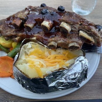 Basin Cafe - Ribs with blueberry BBQ sauce, sautéed vegetables, and cheesy baked potato - Burgers Near Me - Lee Vining, California Basin Cafe - Ribs with blueberry BBQ sauce, sautéed vegetables, and cheesy baked potato - Burgers Near Me - Lee Vining, California