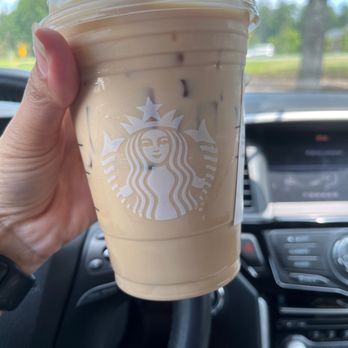 Starbucks - a hand holding a cup of iced coffee - Coffee & Tea Near Me - Kennesaw, Georgia Starbucks - a hand holding a cup of iced coffee - Coffee & Tea Near Me - Kennesaw, Georgia