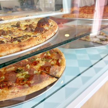 Blondies Pizza - two pizzas in a display case - Pizza Near Me - Toronto, Ontario Blondies Pizza - two pizzas in a display case - Pizza Near Me - Toronto, Ontario