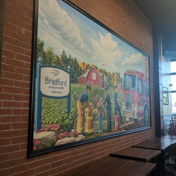 Firehouse Subs - a brick wall with a painting of a farm scene - Delis Near Me - Bradford, Ontario