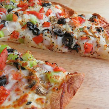 Westside Pizza - two slices of pizza on a cutting board - Pizza Near Me - Chewelah, Washington Westside Pizza - two slices of pizza on a cutting board - Pizza Near Me - Chewelah, Washington