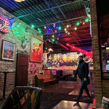 Oddfellows Liquor Bar - a man walking through the bar - Bars Near Me - Cincinnati, Ohio