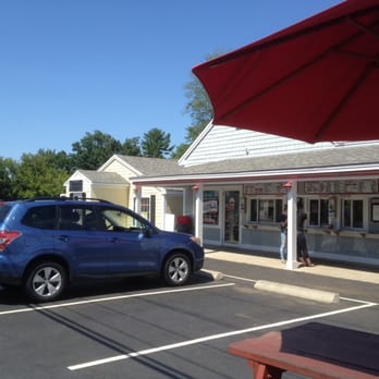 Moo's Place Homemade Ice Cream - Plentiful picnic tables with umbrellas offer a busy streetside scene while you enjoy your cool treat. - Ice Cream & Frozen Yogurt Near Me - Derry, New Hampshire Moo's Place Homemade Ice Cream - Plentiful picnic tables with umbrellas offer a busy streetside scene while you enjoy your cool treat. - Ice Cream & Frozen Yogurt Near Me - Derry, New Hampshire
