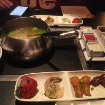 The Melting Pot - From left to right: BBQ pork, shrimp, chicken, and teriyaki sirloin with various dipping sauces. - Fondue Near Me - Fort Collins, Colorado The Melting Pot - From left to right: BBQ pork, shrimp, chicken, and teriyaki sirloin with various dipping sauces. - Fondue Near Me - Fort Collins, Colorado