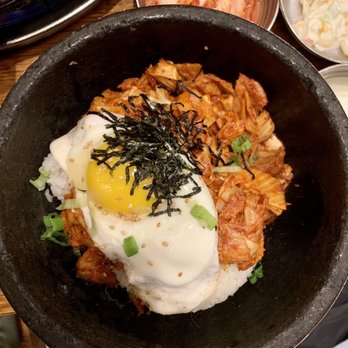 Jongro BBQ Flushing - Kimchi Pork Belly Gobdol (bibimbap) - A Korean dish featuring rice with a fried egg, kimchi, and shredded seaweed, garnished with green onions, accompanied by side dishes of kimchi and salad. - Korean Near Me - Flushing, New York