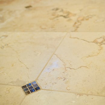 NEST design build - a tile floor with a broken tile - General Contractors Near Me