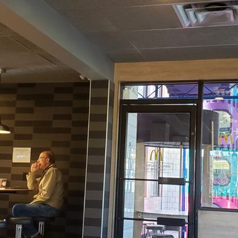 McDonald's - a man sitting at a table - Fast Food Near Me - Kamloops, British Columbia