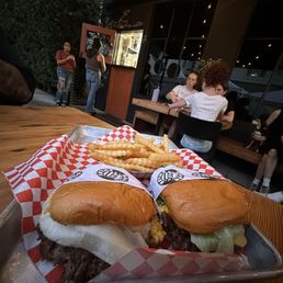 Two single smash burgers with cheese and grilled onions. Two single smash burgers with cheese and grilled onions.