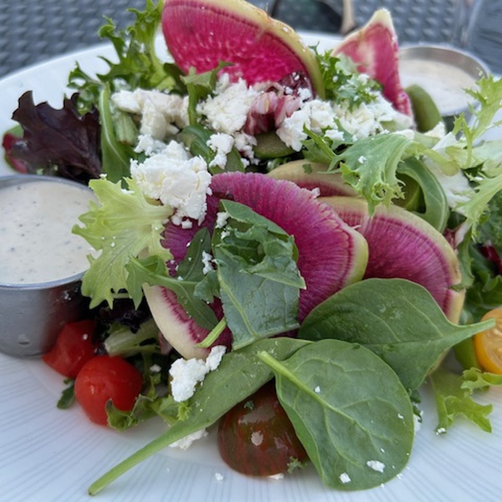 Over The Charles Rooftop Bar - Mixed green salad with vinaigrette dressing on side. - Tapas/Small Plates Near Me - Boston, Massachusetts Over The Charles Rooftop Bar - Mixed green salad with vinaigrette dressing on side. - Tapas/Small Plates Near Me - Boston, Massachusetts