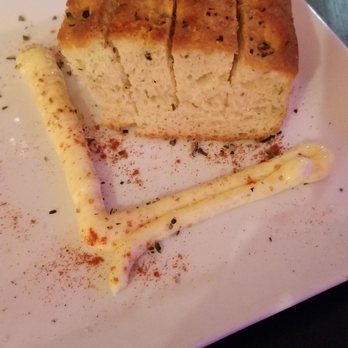 nyloS - The savory rosemary bread at nyloS with a very spicy and garlicky butter. - New American Near Me - Paia, Hawaii nyloS - The savory rosemary bread at nyloS with a very spicy and garlicky butter. - New American Near Me - Paia, Hawaii