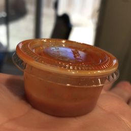 a hand holding a plastic container a hand holding a plastic container