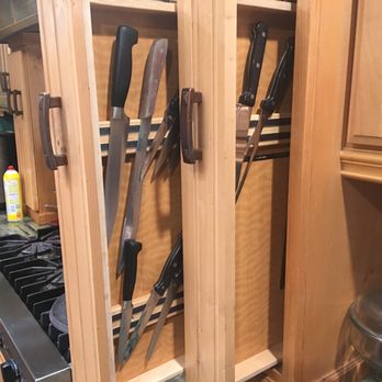 Custom Craft - a kitchen cabinet with knives in it - Interior Design Near Me