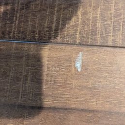 Gouged flooring, cut down to the white base layer.