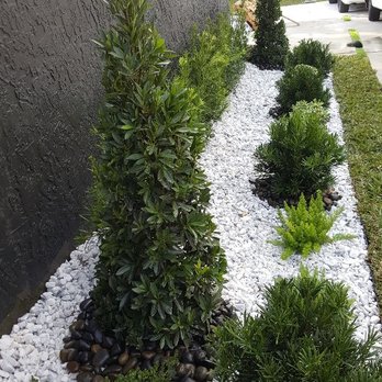 JM Xelandscaping - a garden with white rocks and plants - Landscaping Near Me JM Xelandscaping - a garden with white rocks and plants - Landscaping Near Me