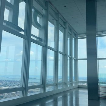 View Boston - Views - A spacious interior of a high-rise observation deck features large glass windows offering a cityscape view and reflections on the polished floor. - Observatories Near Me - Boston, Massachusetts