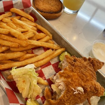 Sweet Caroline’s Kitchen & Cocktails - Chicken sandwich with fries...my hockey puck bun on the counter - Sports Bars Near Me - Ames, Iowa