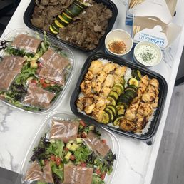 Family Meal for 6 (6 Chicken, House Salad, Tzatziki Sauce) and for 4 (4 Gyro Meat, House Salad, Spicy Harissa Hummus) with Pita Bread Family Meal for 6 (6 Chicken, House Salad, Tzatziki Sauce) and for 4 (4 Gyro Meat, House Salad, Spicy Harissa Hummus) with Pita Bread