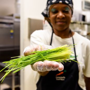 Campbell's Nutrition Center - a woman in a kitchen holding a bunch of green grass - Vitamins & Supplements Near Me - Des Moines, Iowa Campbell's Nutrition Center - a woman in a kitchen holding a bunch of green grass - Vitamins & Supplements Near Me - Des Moines, Iowa