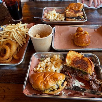 Apocalypse BBQ - Pictured are the Boss burger, brisket sandwich, Mac n' cheese, onion rings, fries and cornbread. - Food Trucks Near Me - Miami, Florida