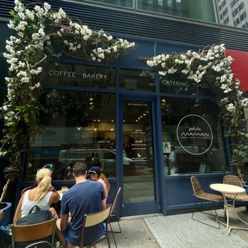 {petite} maman - a woman standing in front of a coffee shop - Cafes Near Me - New York, New York